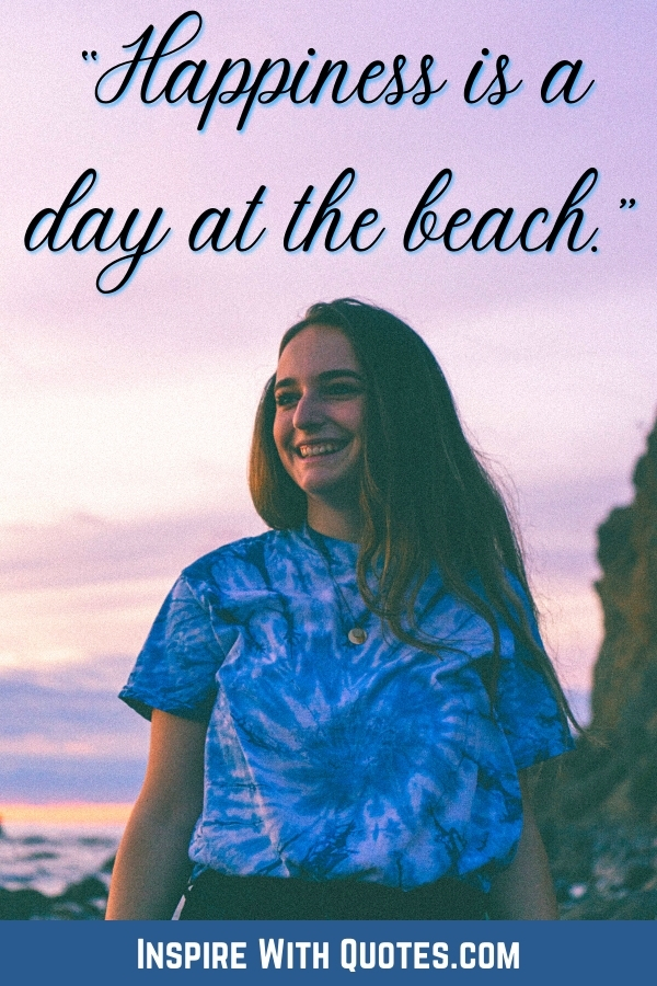 woman smiling with a beach in the background and the quote "happiness is a day at the beach"